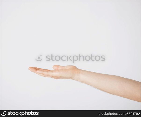 close up of mans hand showing something