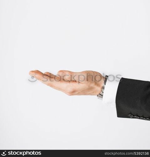 close up of mans hand showing something