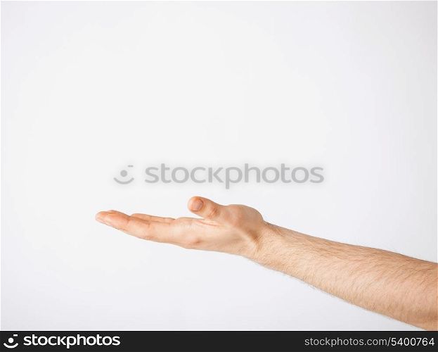 close up of mans hand showing something