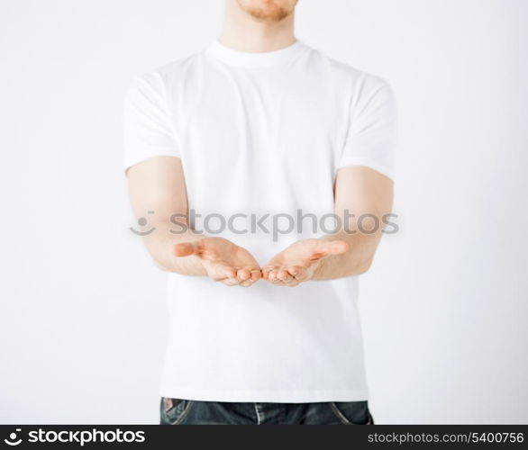 close up of mans hands showing something