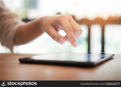 Close up of mans hands using tablet on counter