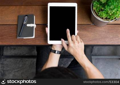 Close up of mans hands using tablet on counter, Image taken from above