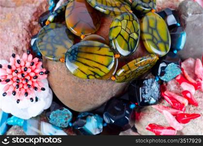 Close up of many different colorful natural gems: agate onyx, coral