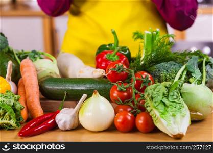 Close up of many healthy vegetables on kitchen table. Various colorful veggies, vegetarian meal ingredients.. Close up of vegetables on table