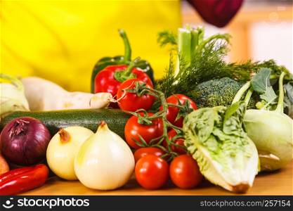 Close up of many healthy vegetables on kitchen table. Various colorful veggies, vegetarian meal ingredients.. Close up of vegetables on table