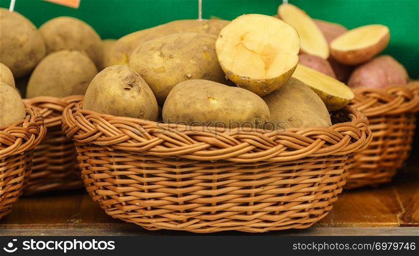 Close up of many potatoes in wicker basket. Vegetarian healthy food concept.. Potatoes in wicker basket
