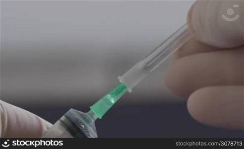 Close up of Medical hand putting the cap on hypodermic needle