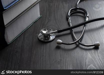 Close-up Of Medical Stethoscope On desk with books