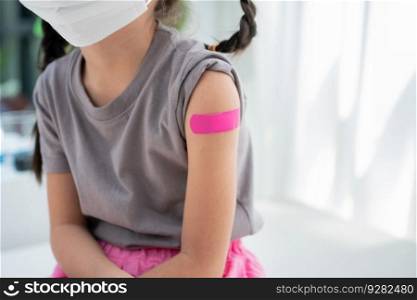 Close-up of medicinal plaster after vaccinated in shoulder of Asian girl kids in hospital. Pediatrician makes vaccination for kids. Vaccination, immunization, disease prevention concept.