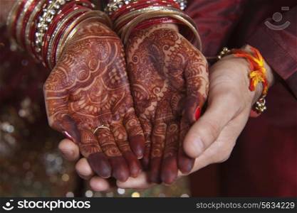 Close-up of mendi on a brides hands