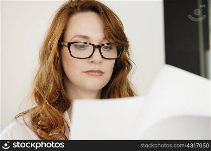 Close up of mid adult businesswoman reading paperwork