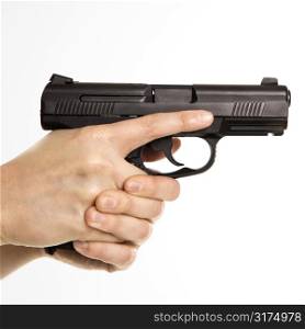Close up of mid adult female Caucasian law enforcement officer hands on gun aiming.