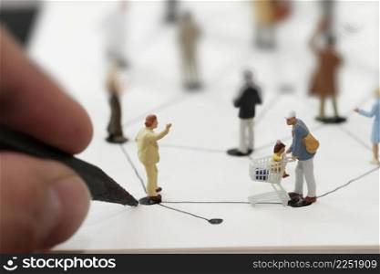 close up of miniature people with hand drawing social network diagram on open notebook on wooden desk as social media conept