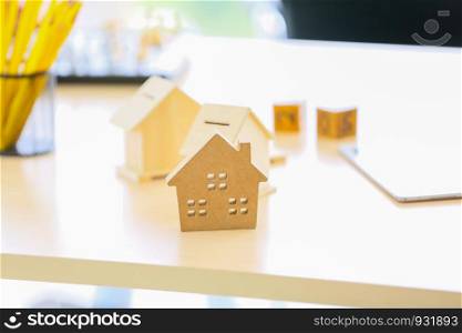 Close-Up Of Model Home On Wooden Table for Real Estate and loan concept