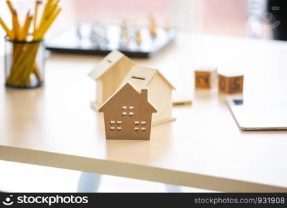 Close-Up Of Model Home On Wooden Table for Real Estate and loan concept