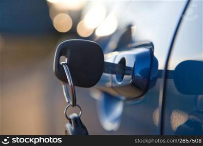Close up of modern car key in lock of car