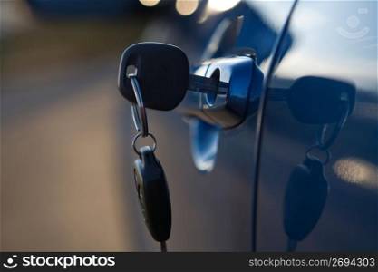 Close up of modern car key in lock of car
