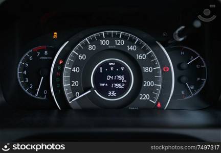 Close up of modern speedometer display in a car dashboard panel .