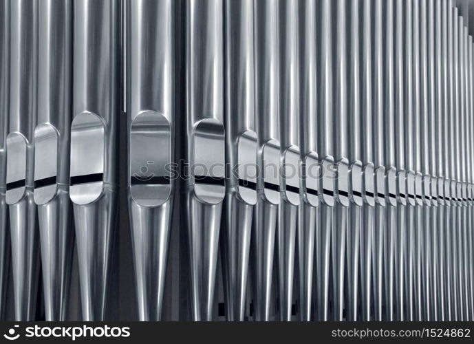 Close-up of modern steel organ pipe set horizontal. Organ pipes close