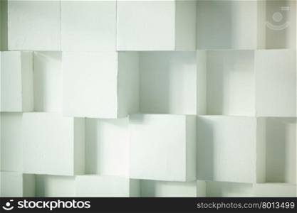 Close-up of modern white wall made of cubes. Modern wall made of cubes