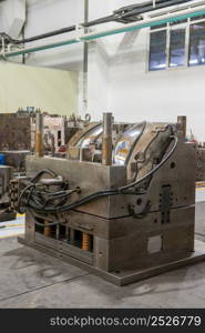 close-up of molds, machine and equipment for production of automotive headlight. press form machine for car headlamps