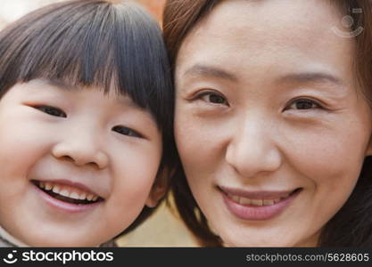 Close-up of Mother and Daughter smiling in the park, autumn, Portrait