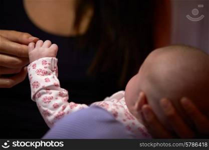 Close Up Of Mother Holding Newborn Baby&#39;s Hand