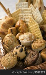 Close-up of muffins and crackers in a wicker basket