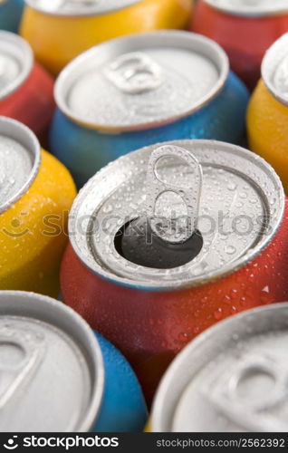 Close Up Of Multi Colored Soda Cans With One Open