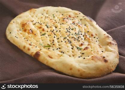 Close-up of naan topped with sesame seeds