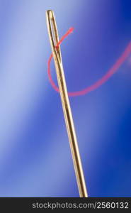 Close Up Of Needle And Red Thread