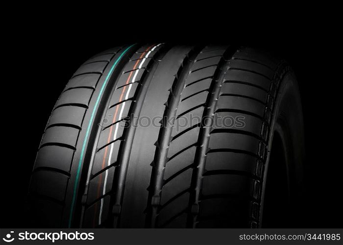 close up of new sport summer tire, over black, studio shot