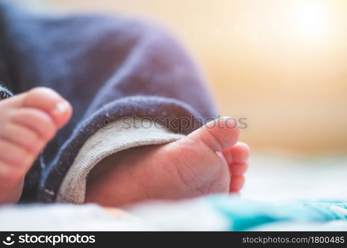 Close up of newborn baby feet on baby blanket