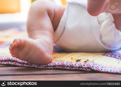 Close up of newborn baby feet, outdoors on baby blanket