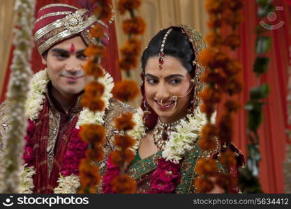 Close-up of newlywed couple looking away