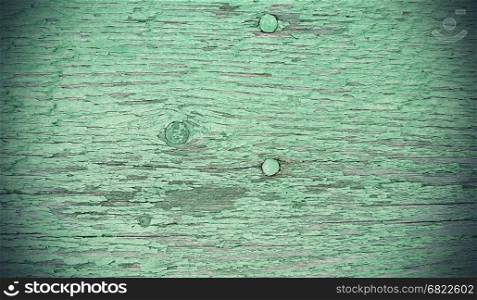 Close-up of old green painted weathered wooden vintage texture with nails