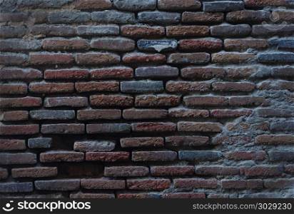 Close up of old vintage red brick wall surface. Old destroyed brick wall background