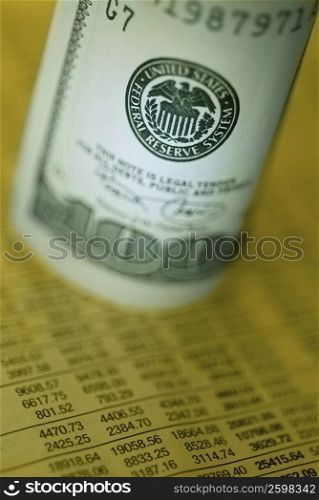 Close-up of one hundred dollar bill on a financial page