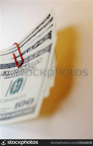 Close-up of one hundred dollar bills with paper pins