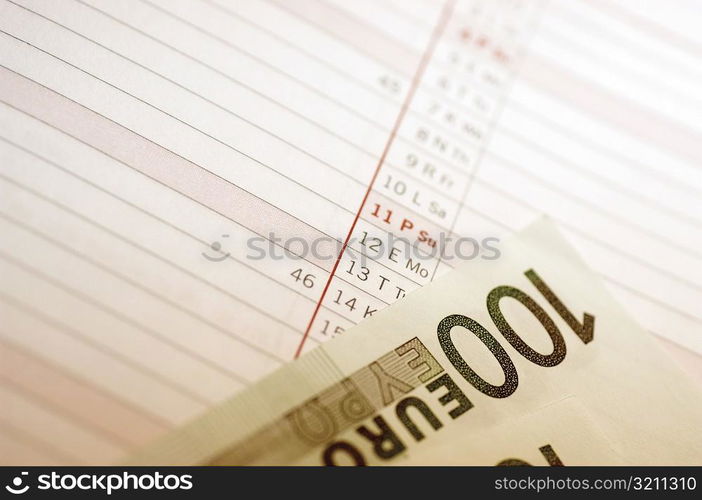 Close-up of one hundred Euro banknote on a personal organizer