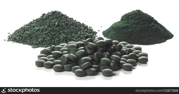 Close up of organic spirulina tablets, flakes and powder over white background. . Spirulina flakes, tablets and powder over white background.
