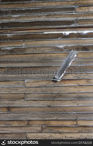 Close up of outside of rustic wooden plank building.