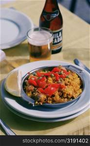 Close-up of paella rice dish with a glass of beer, Granada, Andalusia, Spain