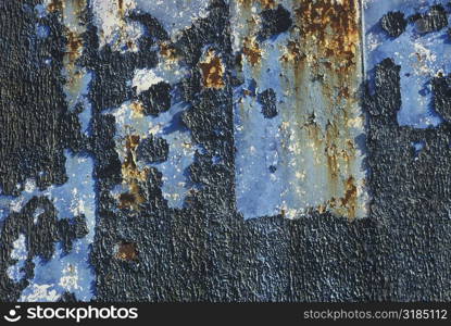 Close-up of paint peeling off a metal surface