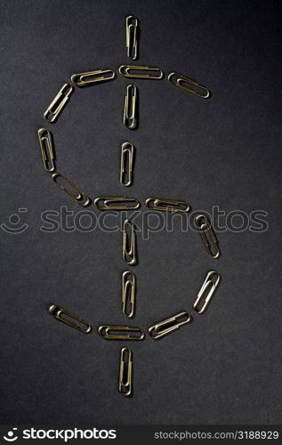 Close-up of paper clips in the shape of Dollar symbol