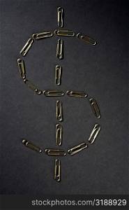 Close-up of paper clips in the shape of Dollar symbol