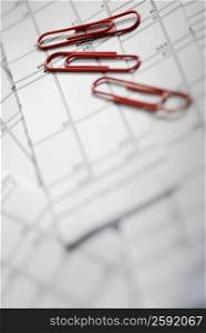 Close-up of paper clips on documents