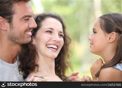 Close up of parents laughing with daughter
