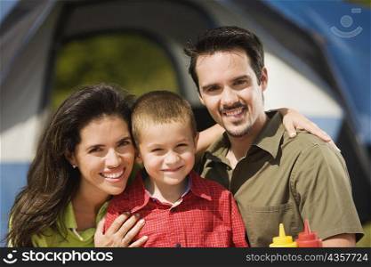 Close-up of parents smiling with their son