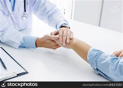 close up of patient and consultant doctor give an advice in a hospital or clinic